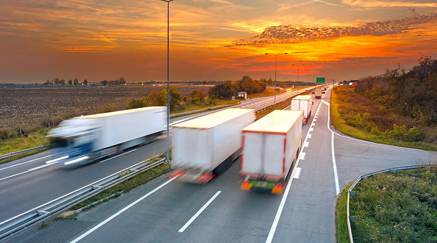 Several trucks in motion blur on the highway at sunset, near Belgrade - Serbia